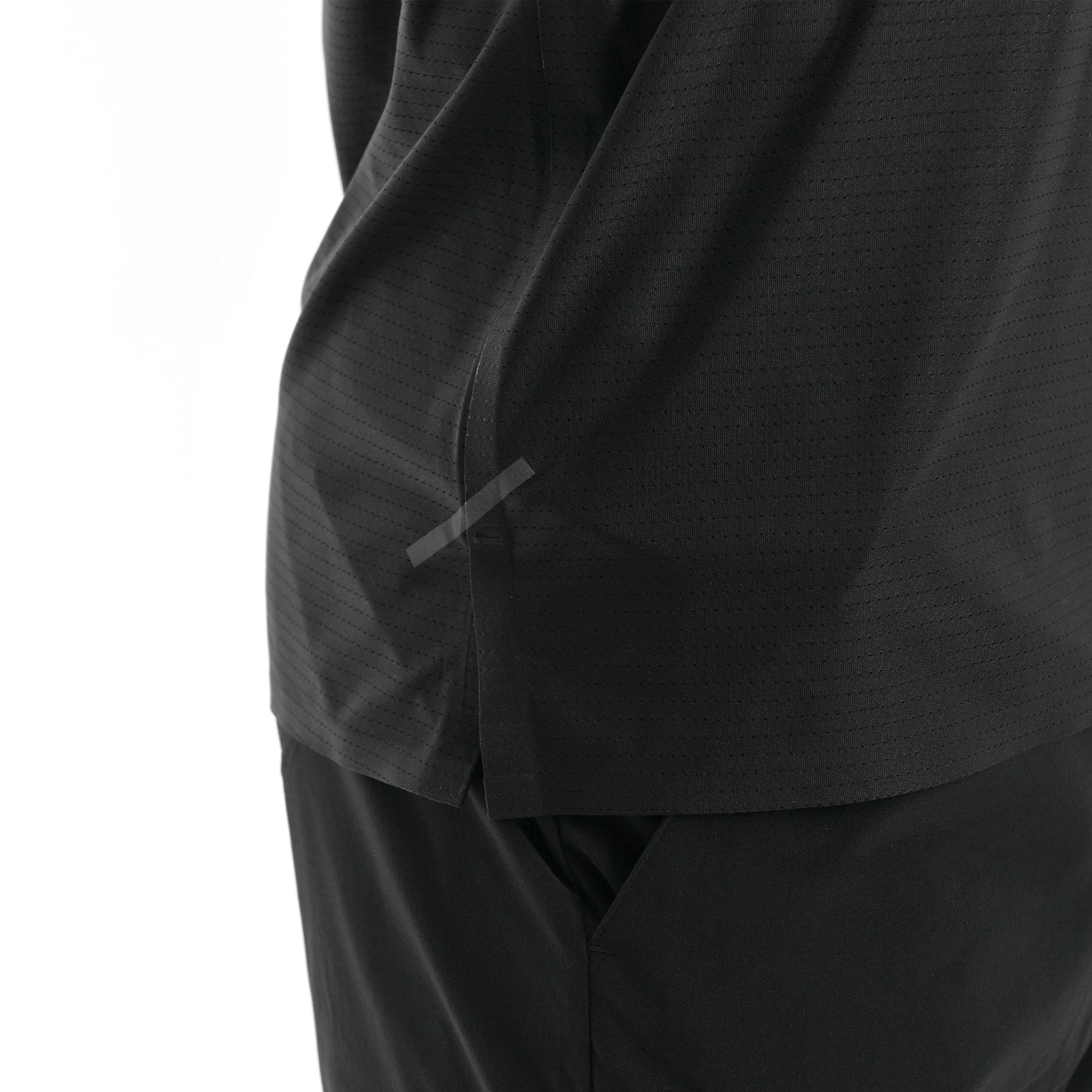 Close-up of a black garment with a tape on a white background. 